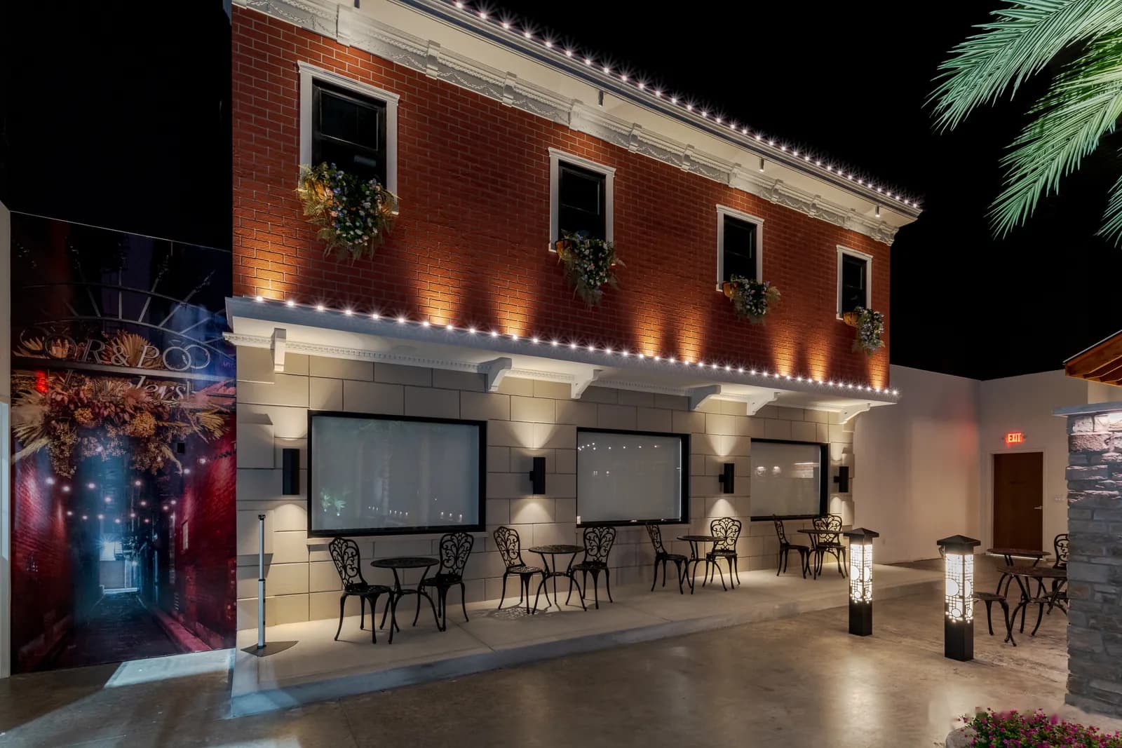 Café storefront with warm white permanent roofline and canopy lighting