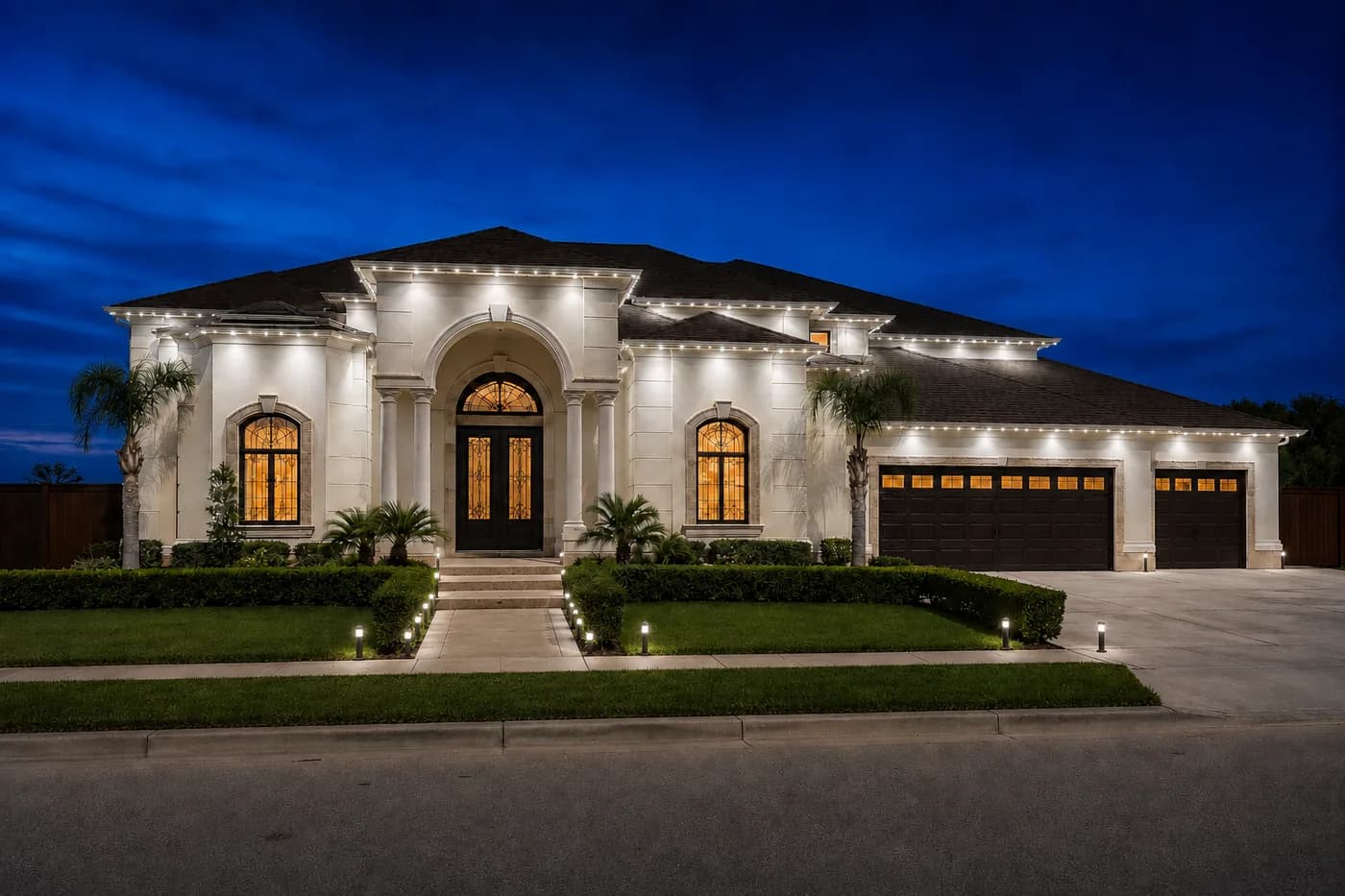 Executive home with roofline lighting and path lights along the walk and driveway