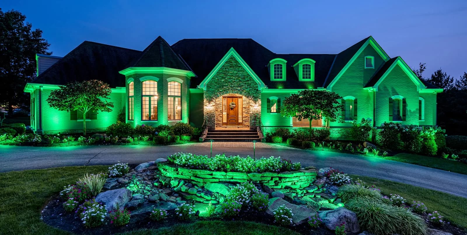 Home and landscape lit in green for a holiday scene